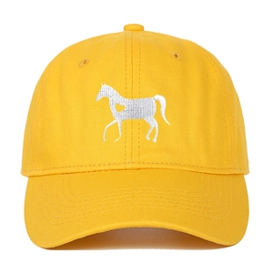 Close-up of yellow cotton baseball cap featuring detailed white horse embroidery and heart detail