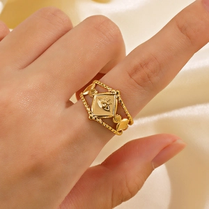 Adjustable gold geometric rhombic ring with evil eye motif on a silk background