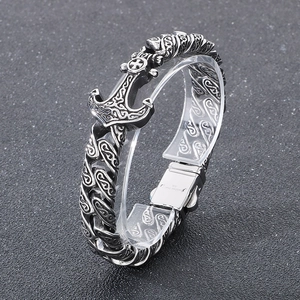 Close-up of vintage steel anchor bracelet with intricate viking weave pattern