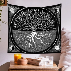Detail of black and white tree of life tapestry in a cozy bohemian room setting