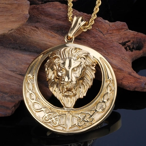 Detailed view of a gold lion head pendant with a twisted chain on dark wood background