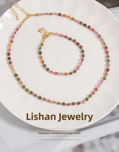 Macro view of colorful tourmaline bead necklace and bracelet set with gold metal spacers