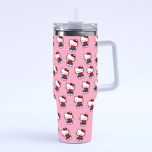 Close-up of pink 40oz tumbler with cartoon cat patterns and ergonomic white handle