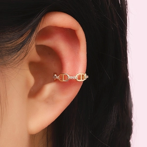 Detailed view of a gold-plated anchor chain ear cuff featuring micro-pave crystals
