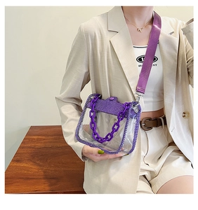 Close-up of purple transparent PVC bag with rhinestones and chunky resin chain handle