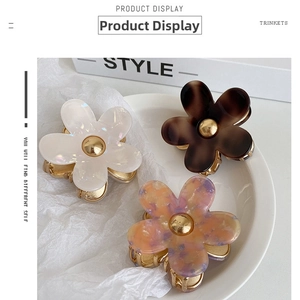 Detailed trio of floral acetate hair claws with gold metal bases in various colors