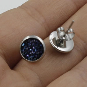Macro view of 8mm stainless steel stud earrings with deep purple sparkling druzy stones