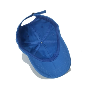 Detail showing the inner structure, stitching, and adjustable strap of the royal blue cap