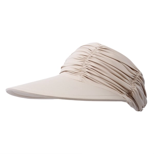 Detail of the pleated beige sun hat showing the wide brim and breathable fabric texture