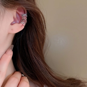 Detailed close-up of a silver multi-layer crisscross ear cuff with zircon accents