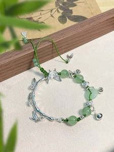 Detailed close-up of Chinese style butterfly bamboo bracelet with green jade beads