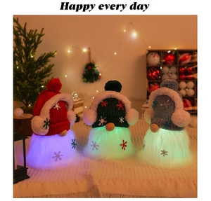 Three glowing Christmas gnomes with knitted hats and LED beards for holiday decor