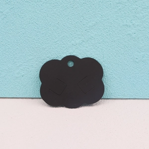 Close-up of black cloud-shaped paper display card for earrings and jewelry organizing