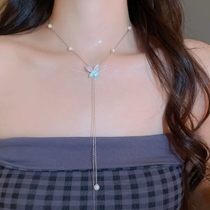 Detail of Korean style butterfly necklace with pearls and zircon tassels on neck