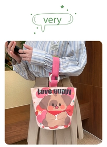 Detail of canvas bucket bag featuring cute puppy print and pink straps with resin ring