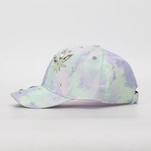 Detail view of kids tie-dye baseball cap with sparkling rhinestone flower decoration