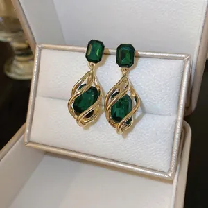 Elegant geometric waterdrop emerald stone earrings with golden spiral metal frame