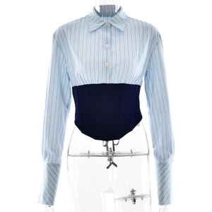 Women's blue striped long sleeve polo shirt with navy corset waist on a mannequin