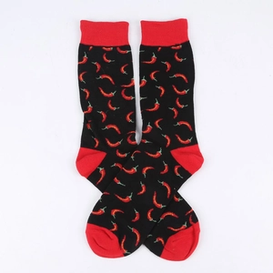 Detail shot of black mid-calf socks with red chili pepper pattern and ribbed cuffs