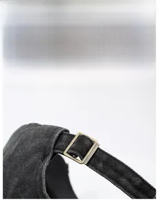 Detailed macro view of adjustable metal buckle on washed vintage cotton baseball cap