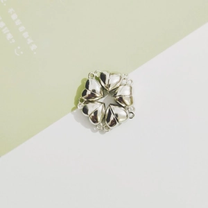 Macro shot of silver heart-shaped magnetic clasp connectors for DIY jewelry making