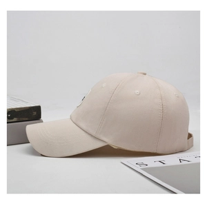 Detail of beige canvas baseball cap with reinforced stitching and breathable eyelets