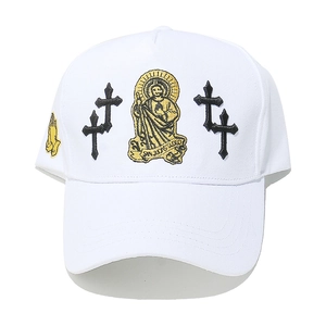 Close-up of white baseball cap with San Jude Tadeo embroidery and black gothic crosses