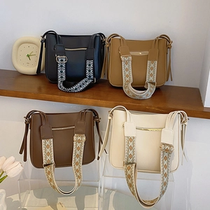 Set of four stylish PU leather bucket bags in black, brown, and cream with wide woven straps