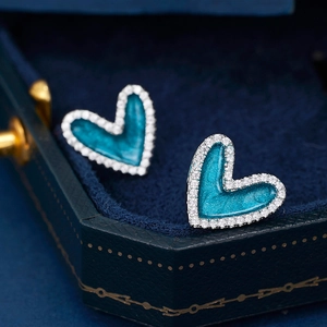 Elegant 925 sterling silver heart stud earrings with blue enamel and crystal halo
