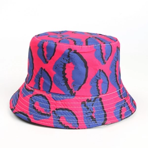 Detail of pink cotton bucket hat featuring blue lip prints and white stitching