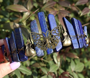 Close-up of lapis lazuli crystal crown with bronze butterfly and bird skull ornaments