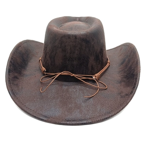 Detail of dark brown faux suede cowboy hat featuring vintage texture and leather rope trim