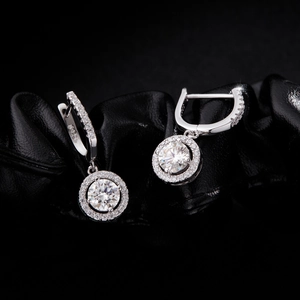 Sparkling S925 sterling silver halo hoop earrings with round brilliant stones on black fabric