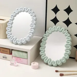 Modern wavy edge desktop vanity mirrors in pastel blue and green for dorm decor