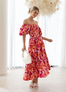 Detailed view of elastic pleated bodice and puff sleeves on floral maxi dress