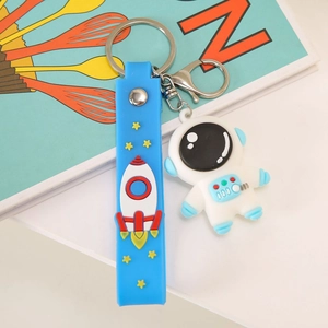 Porte-clés astronaute avec dragonne en silicone bleue à motifs de fusée et d'étoiles