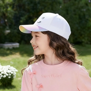 Detail of kids baseball cap with white fabric, rainbow sequin brim, and cartoon embroidery