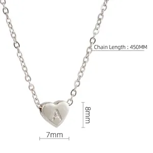 Macro shot of silver heart pendant with letter A engraving and chain dimension detail