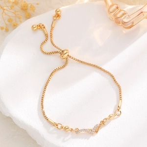 Detail of adjustable gold bolo bracelet with V-shaped pavé zircon and sleek square chain