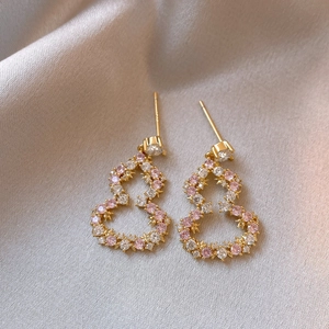 Elegant hollow gourd earrings in gold finish with pink and white rhinestones on silk