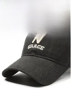 Detail of embroidered N letter on vintage denim baseball cap with sturdy curved brim
