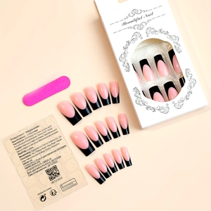 Detail view of pink and black French press-on nails set with adhesive tabs and file