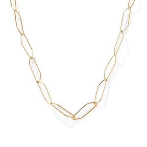 Macro shot of gold-plated elongated hexagonal chain links with high-polish metallic shine