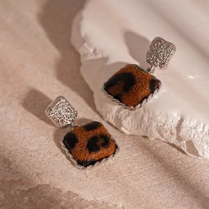 Detail view of square leopard print earrings with silver twisted metal borders