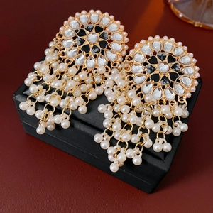 Detailed close-up of vintage heart drop earrings with black enamel and white pearl tassels