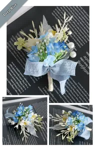 Detail of dark blue and white handmade boutonniere with silk ribbon and pearl accents