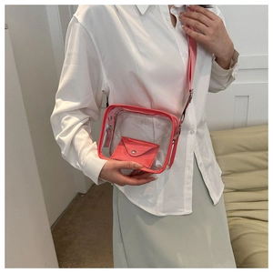 Detailed shot of pink transparent jelly crossbody bag worn by a model in casual attire