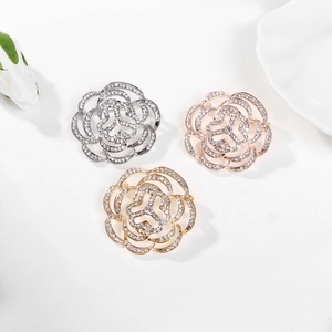 Sparkling crystal camellia flower brooches set in silver, gold and rose gold finishes