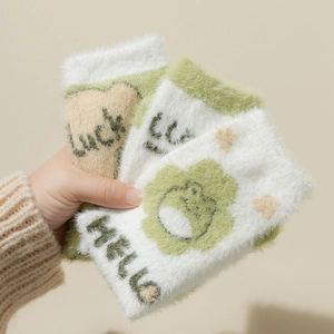 Stack of thick green frog fuzzy socks made of mink velvet with Lucky lettering