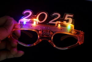 Close-up of 2025 LED glowing glasses with orange transparent frame and multicolor lights